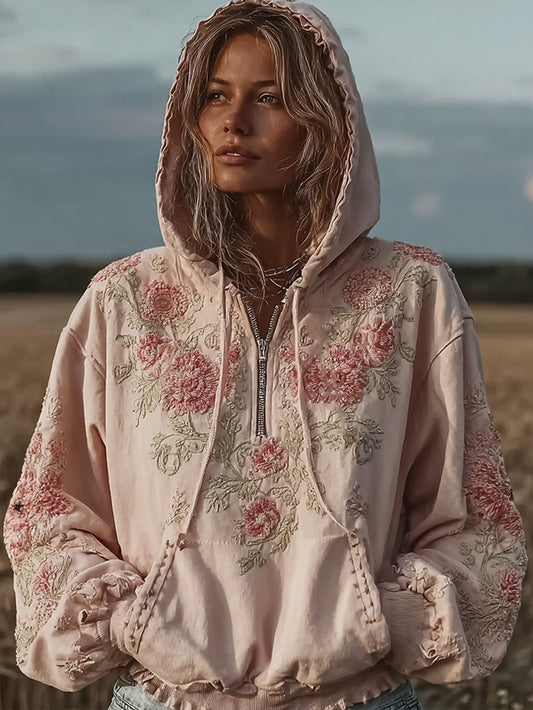 Kvinnlig, avslappnad hoodie i ljusrosa med blommönster