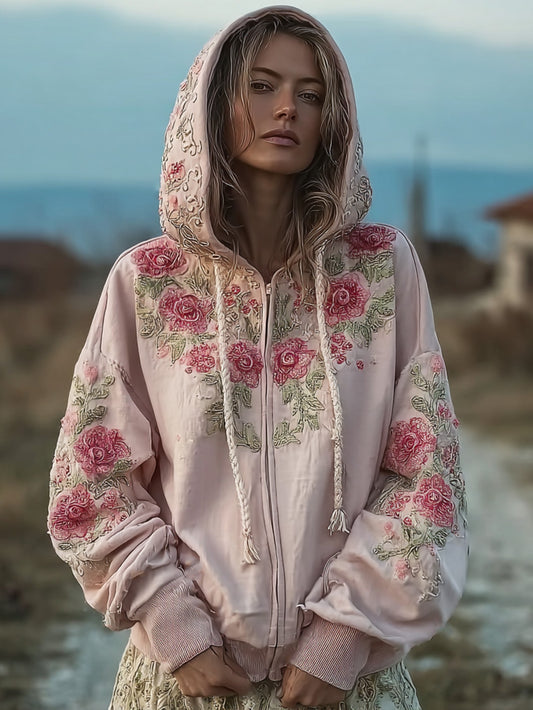 Kvinnlig, avslappnad hoodie i ljusrosa med blommönster