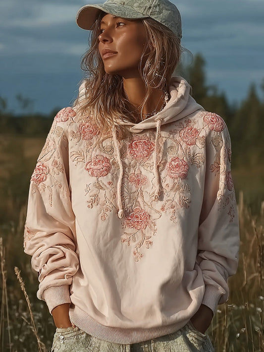 Kvinnlig, avslappnad hoodie i ljusrosa med blommönster