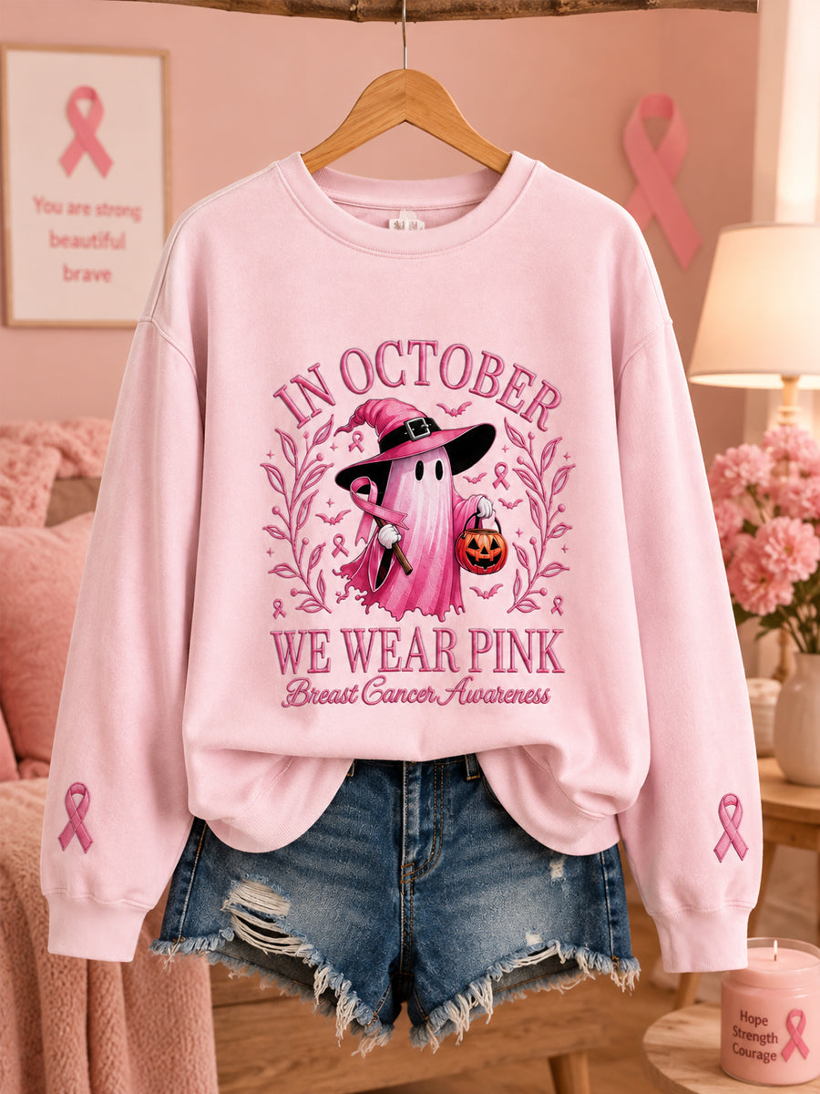 Kvinnors oktoberkläder – rosa sweatshirt med spöktryck, i anslutning till bröstcancerkampanjen