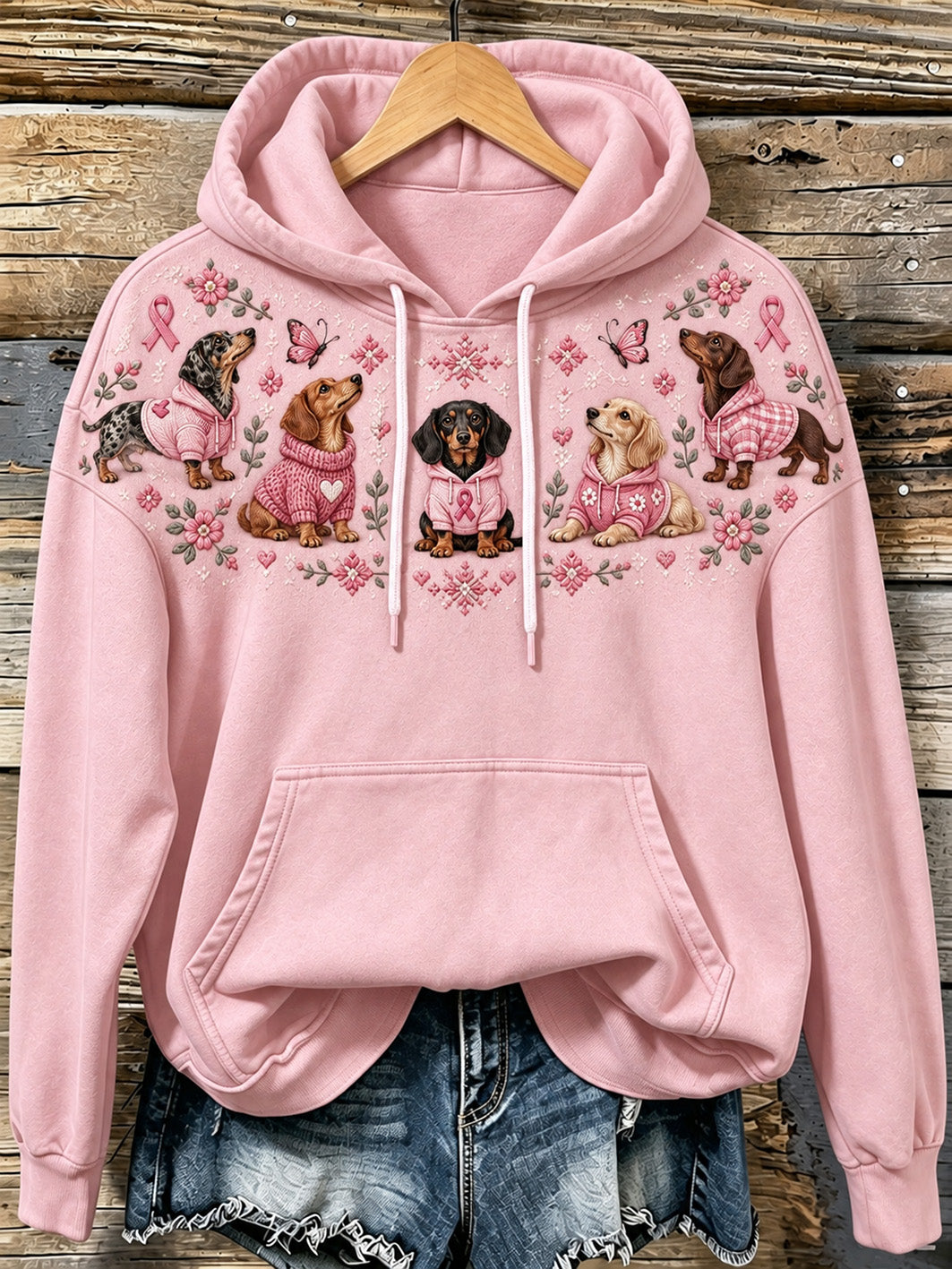 Kvinnlig huvtröja med hundmönster och rosa välgörenhetsband, avslappnad stil